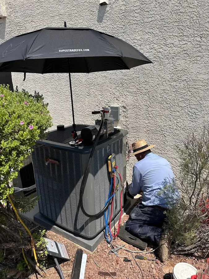 HVAC technician performing outdoor AC maintenance in Dowagiac